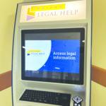 A photo of a touch screen kiosk offering free legal assistance